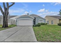 Charming single-story home featuring a two-car garage, arched entryway, and well-maintained landscaping at 1808 Westpointe Cir, Orlando, FL 32835