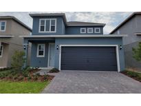 Charming two-story home featuring an attached two-car garage and complementary landscaping at 2148 Keystone Pass Blvd, Minneola, FL 34715