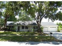 Charming single-story home with a well-maintained lawn and mature trees in a quiet neighborhood setting at 40 N Triplet Lake Dr, Casselberry, FL 32707
