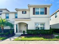 Charming two-story home with a well-maintained lawn, decorative shutters, and a welcoming front porch at 4810 Memories Ln, Kissimmee, FL 34746