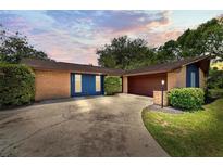 Charming single-story brick home featuring a two-car garage and well-manicured landscaping at 35338 Lake Unity Rd, Fruitland Park, FL 34731
