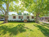 Charming single story home featuring a well-manicured lawn and mature shade trees at 36812 Skycrest Blvd, Fruitland Park, FL 34731