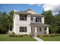 Charming two-story home with a landscaped yard, welcoming entrance and a neutral color palette at 5113 Blanket Flower Way, Apopka, FL 32712