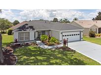 Well-maintained home featuring lovely landscaping and a two-car garage at 670 Fayette Ct, The Villages, FL 32162