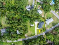 A beautiful aerial view showcasing the property's layout, mature trees, and large yard at 16615 Oklahoma St, Clermont, FL 34715