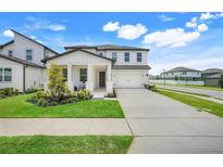 Charming two-story home featuring a covered front porch and a well-manicured lawn at 2161 Gold Dust Dr, Minneola, FL 34715