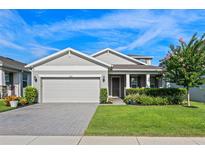 Charming single-story home featuring a manicured front yard, attached two-car garage, and inviting entryway at 3467 Buoy Cir, Winter Garden, FL 34787
