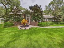 Charming single-story home with a lush lawn and mature landscaping at 4207 Bair Ave, Fruitland Park, FL 34731