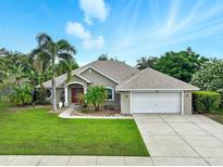 Charming single-story home with well-manicured lawn, mature trees, and a two-car garage at 4401 Abaco Dr, Tavares, FL 32778