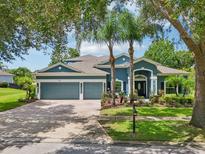 Beautiful two-story home with a three car garage, mature landscaping and elegant curb appeal at 6048 Tremayne Dr, Mount Dora, FL 32757