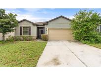 Charming single-story home featuring a well-maintained lawn and a neutral two-car garage at 120 Citrus Isle St, Davenport, FL 33837