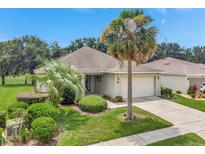 Beautiful single-story home featuring a lush, landscaped front yard and inviting two-car garage at 3507 Arlington Ridge Blvd, Leesburg, FL 34748