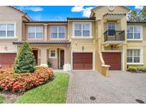 Charming townhomes with beautiful landscaping, garages, and brick paver driveways in a well-maintained community at 4814 Luge Ln, Orlando, FL 32839