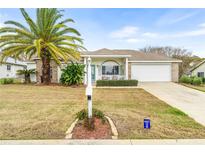 Single story home with brick accents, palm tree, and a two-car garage at 5315 Nw 25Th Loop, Ocala, FL 34482