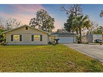 Charming single-story home with well-manicured lawn, two-car garage, and mature trees at 2060 Se 39Th St, Ocala, FL 34480