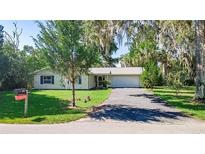 Charming single-story home featuring a well-manicured lawn and an attached two-car garage at 2060 Se 39Th St, Ocala, FL 34480