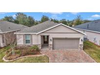 Charming single-story home with well-manicured lawn and brick-paved driveway at 4358 Nw 57Th Ave, Ocala, FL 34482