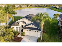 Stunning waterfront home with lush landscaping and a two-car garage at 2251 Oakington St, Winter Garden, FL 34787