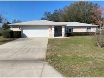 Charming single story home with a two-car garage and well-manicured landscaping, and long drive at 10218 Sw 63Rd Ave, Ocala, FL 34476