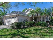 Charming single-story home featuring mature landscaping and an attached two-car garage at 915 Ashmeade Ct, Port Orange, FL 32127