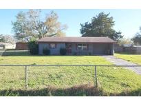 Cozy single-story home featuring a spacious front yard and driveway at 1040 Ne 25Th St, Ocala, FL 34470