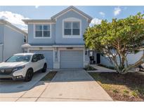 Charming two-story townhouse with a well-manicured lawn and driveway, providing an inviting curb appeal at 4410 Sw 52Nd Cir # 108, Ocala, FL 34474