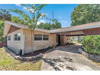 Charming brick home exterior featuring a covered carport and well-maintained landscaping at 8082 Sw 103Rd Ln, Ocala, FL 34481