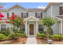 Charming townhome with a well-maintained lawn and a walkway leading to the front door at 2950 Lucayan Harbour Cir # 107, Kissimmee, FL 34746