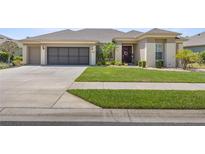 Charming single-story home with a well-maintained lawn and a two car garage at 7274 Sw 95Th Ave, Ocala, FL 34481