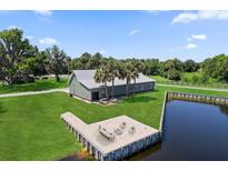 Stunning aerial view of house with a private dock with an outdoor seating area on waterfront property at 3943 Nw 219Th Street Rd, Micanopy, FL 32667