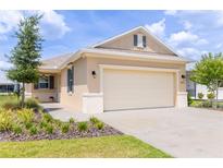 Charming single-story home with a neutral color scheme, well-manicured landscaping, and an attached two-car garage at 8925 Sw 76Th St, Ocala, FL 34481