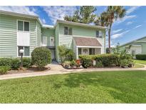 Inviting condo with manicured lawn, mature trees, and charming curb appeal at 487 Midway Dr # B, Ocala, FL 34472