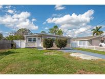 Charming single story home with well-maintained lawn, decorative shrubbery and gray driveway at 1831 Richmond Rd, Lakeland, FL 33803