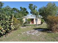 Charming home featuring a well-maintained lawn and mature trees, perfect for outdoor enjoyment at 332 Jackson St, Lake Wales, FL 33859