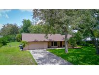Charming single-story home with a two-car garage and mature landscaping at 3567 Red Oak Ct, Lake Wales, FL 33898
