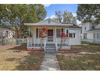 Charming bungalow-style home with a covered front porch and mature landscaping at 720 S Orange Ave, Bartow, FL 33830