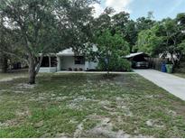 Charming home with a neatly maintained front yard and a covered carport for convenient parking at 1422 Avenue H Sw, Winter Haven, FL 33880