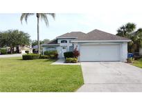 Charming single-Gathering home with a well-manicured lawn, a two-car garage, and lovely landscaping at 2200 Mallory Cir, Haines City, FL 33844