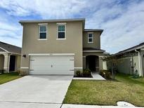 Charming two-story home with a two-car garage and well-maintained lawn at 2655 Swooping Sparrow Dr, Harmony, FL 34773