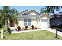 Charming single-story home featuring a well-maintained lawn and complemented by a neatly landscaped garden at 2692 Hemingway Ave, Haines City, FL 33844