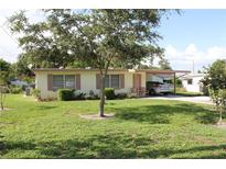 Charming single-story home featuring a well-maintained lawn and convenient covered carport at 7 Lamplight Ln, Winter Haven, FL 33884