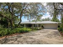 Charming single-story home featuring a spacious driveway, two-car garage, and well-manicured landscaping at 882 Redwood Way, Lake Wales, FL 33898