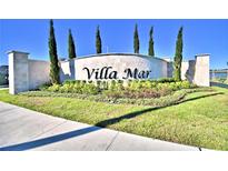 Elegant Villa Mar community entrance sign with lush landscaping and bright blue sky at 1484 Leamington Ln, Winter Haven, FL 33884