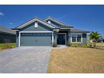 Beautiful one story home featuring a two car garage, tiled roof and well manicured lawn at 4938 Vue Delac Pass, Auburndale, FL 33823