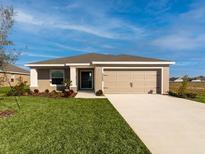 One-story home with attached garage and well-manicured lawn at 2101 Summerlake Dr, Auburndale, FL 33823