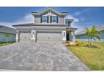 Beautiful two-story home featuring a paved driveway and well-manicured lawn at 4676 Grandview Glen Dr, Auburndale, FL 33823