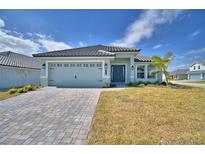 Charming single-story home with a paver driveway, attached two-car garage and a well-maintained lawn at 4687 Grandview Glen Dr, Auburndale, FL 33823