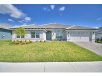 Beautiful single-Gathering home showcasing lush green lawn and an inviting exterior, perfect for Gathering living at 5280 Tennessee Ridge Ct, Auburndale, FL 33823