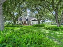 Charming single Gathering home with lush landscaping and mature trees offering beautiful curb appeal at 1096 Drew St, Lakeland, FL 33810