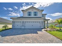 Charming two-story home with a three-car garage and a brick driveway at 4538 Grandview Glen Dr, Auburndale, FL 33823